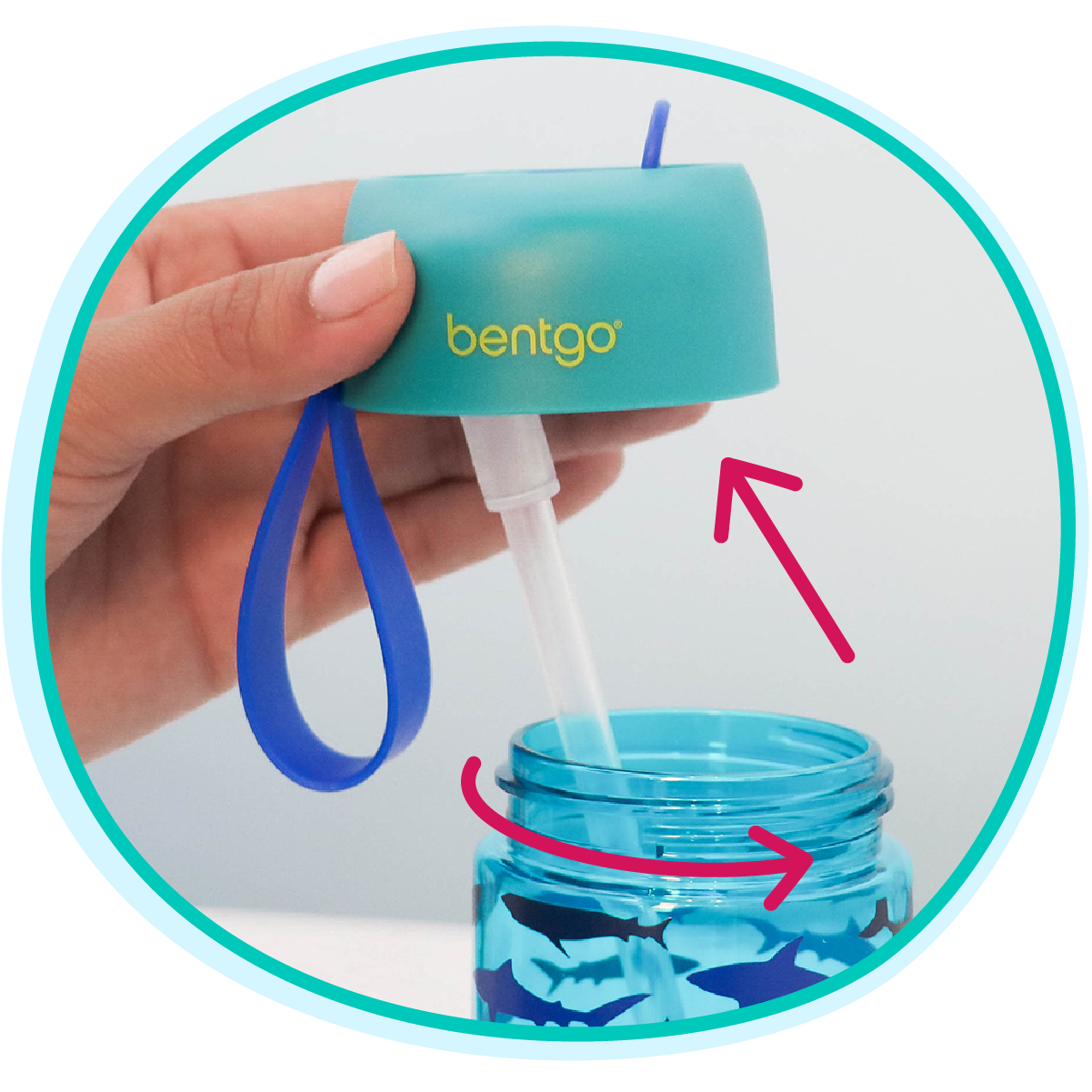 Hand using a Bentgo container with a blue lid and blue handle, dispensing a white substance into a blue container with shark design.