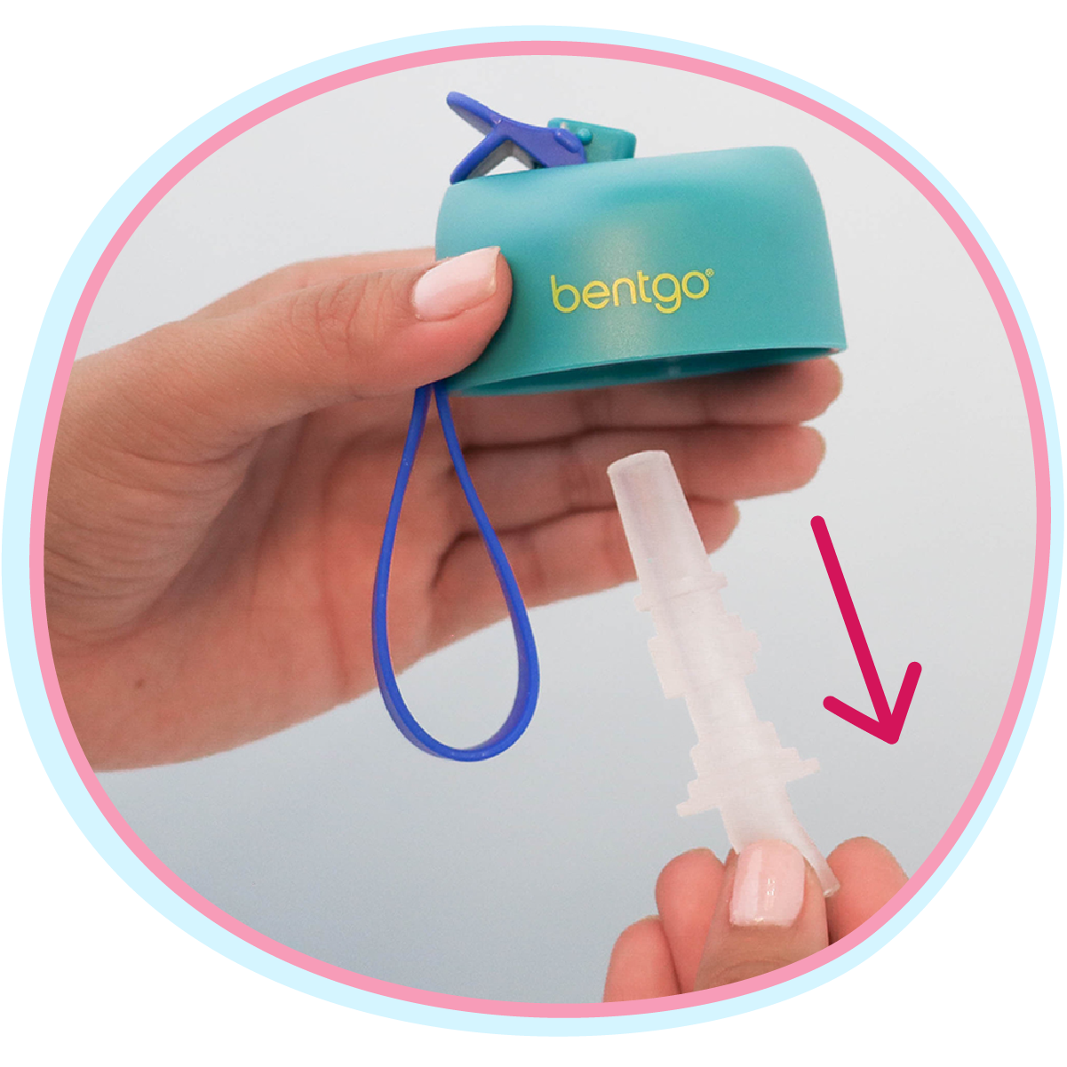 Hand holding a teal Bentgo container with a straw attachment on a light gray background