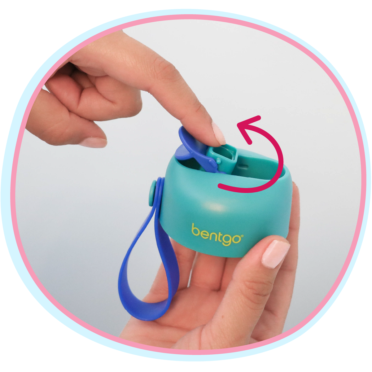 Teal Bentgo container with blue strap held by a hand, showing the strap attachment.