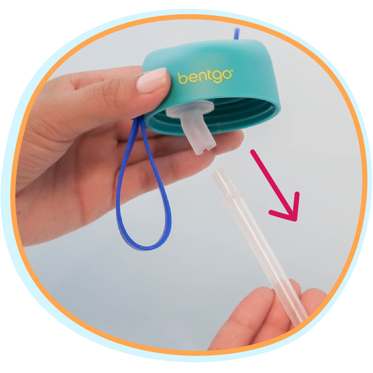 Hand holding a teal Bentgo container with a straw attachment on a light blue background