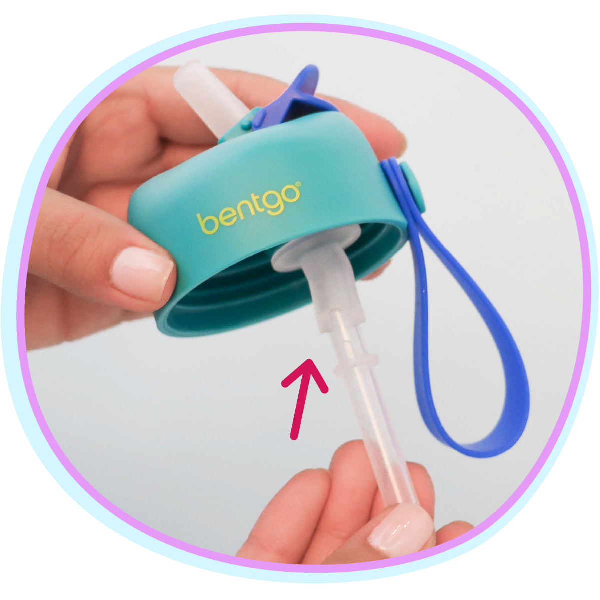 Teal Bentgo container with straw attachment held by a hand on a white background