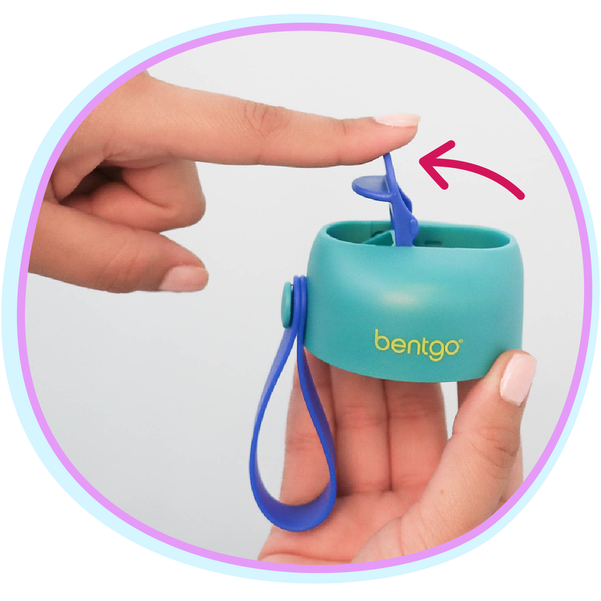 Teal Bentgo container with blue strap held by a hand on a white background